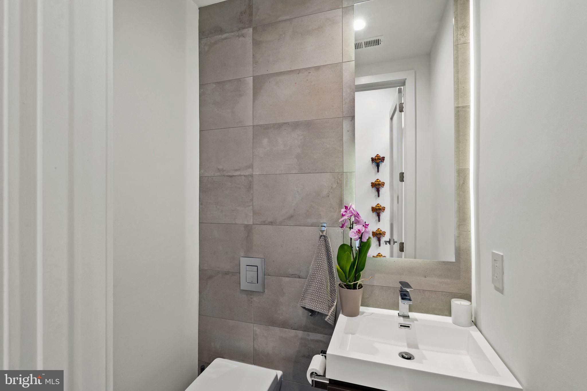 1646 Carlton Street Philadelphia, PA 19103 - Photo 7 of 66 a bathroom with a sink a toilet and a mirror