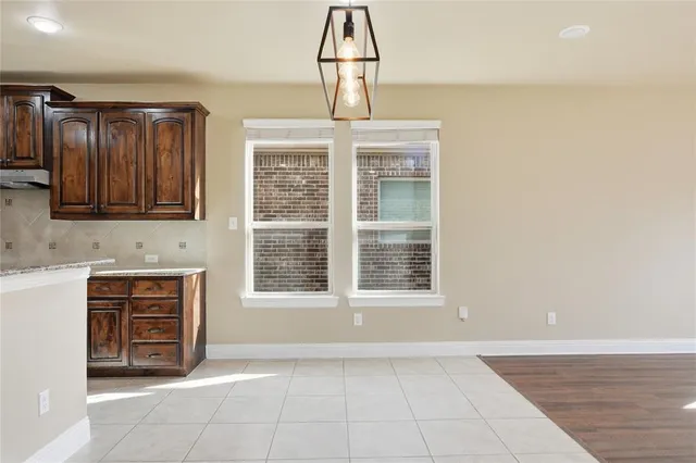 a view of an empty room with a cabinet and a window