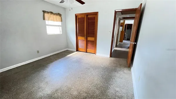 an empty room with a empty space and windows