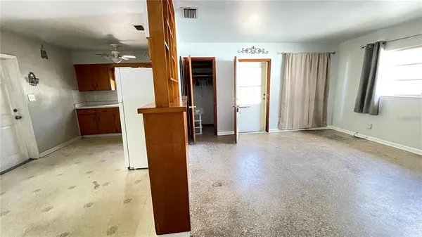 a view of kitchen with refrigerator and window