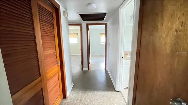 a bathroom with a granite countertop sink a toilet and a mirror