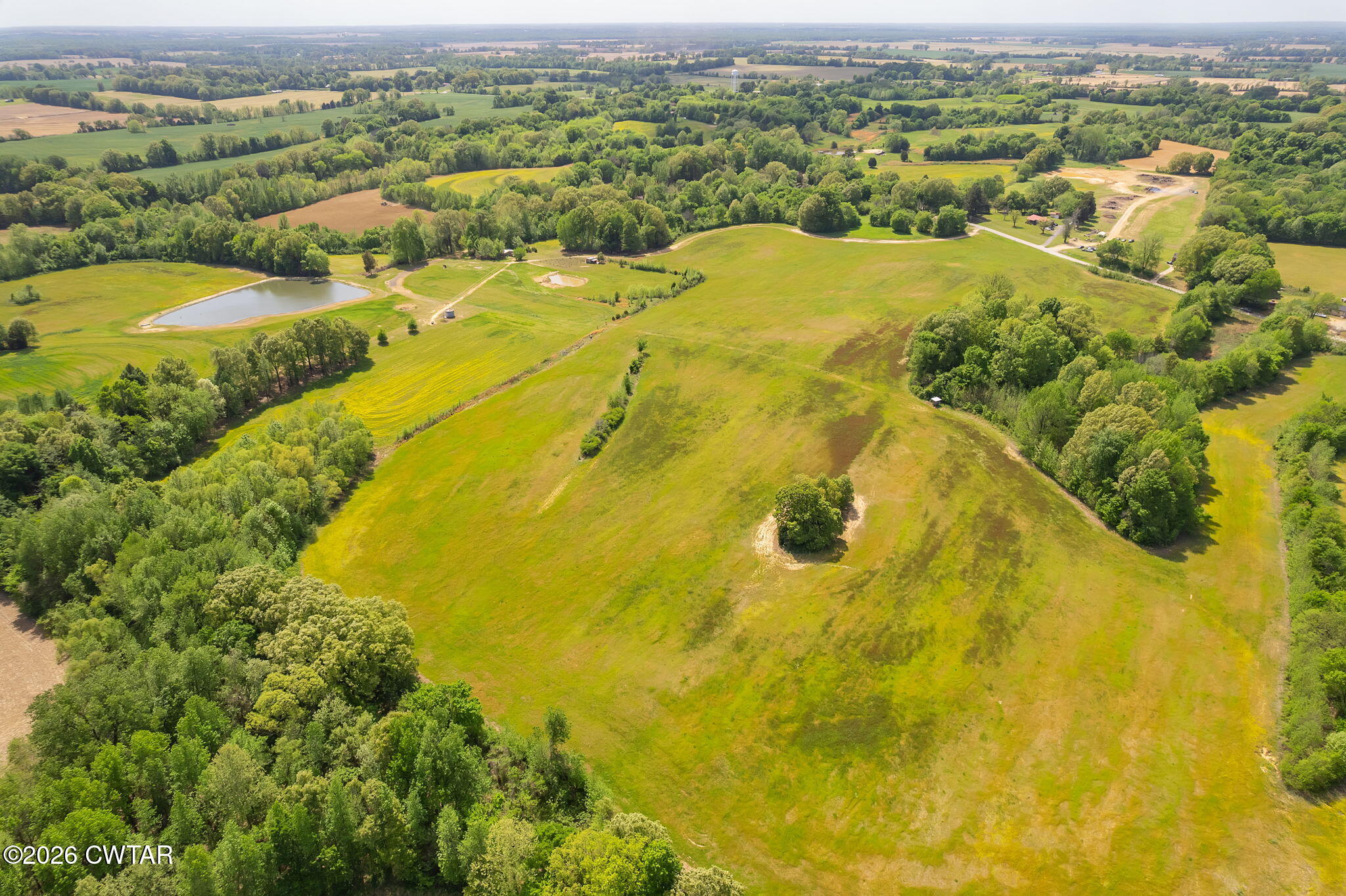 an aerial view of residential houses with outdoor space and swimming pool