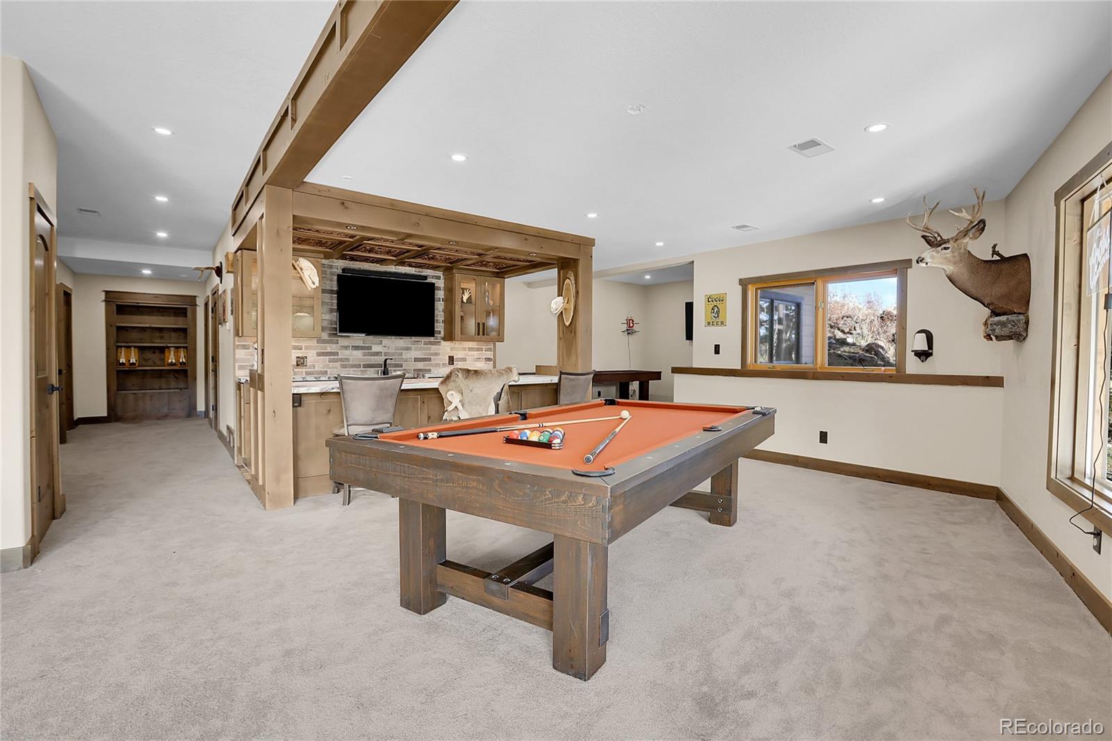 12954 South Ridge Road Conifer, CO 80433 - Photo 12 of 24 a room with furniture a fireplace and a flat screen tv