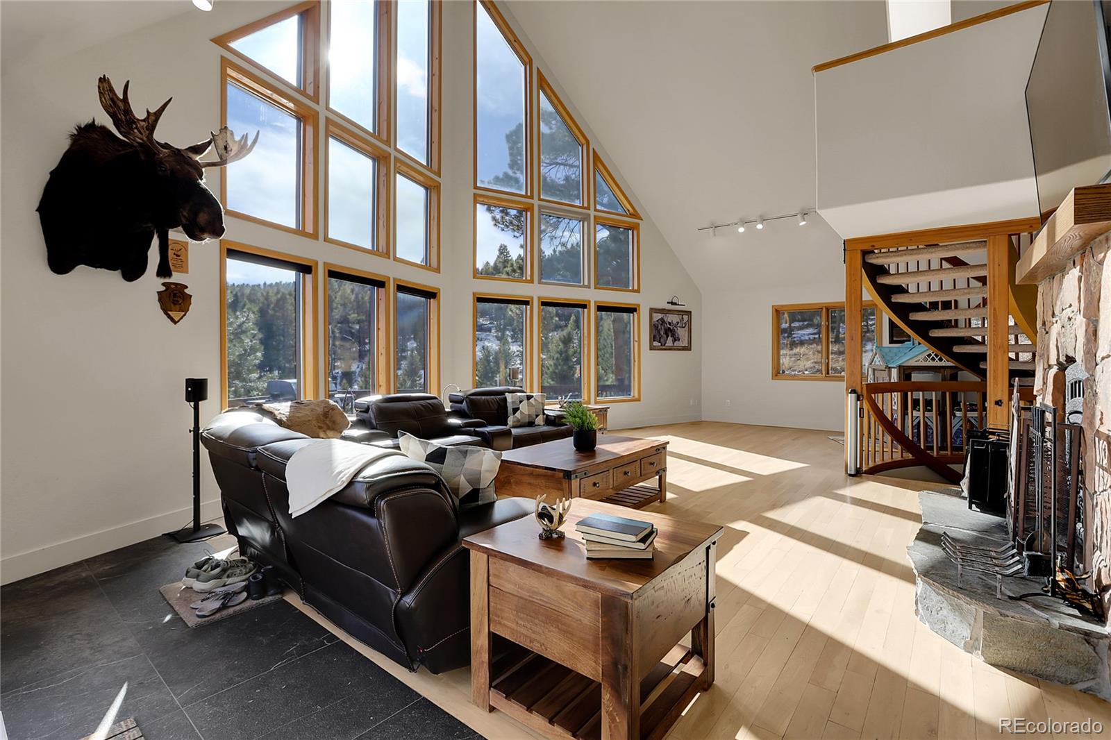 12954 South Ridge Road Conifer, CO 80433 - Photo 5 of 24 a living room with furniture fireplace and a window