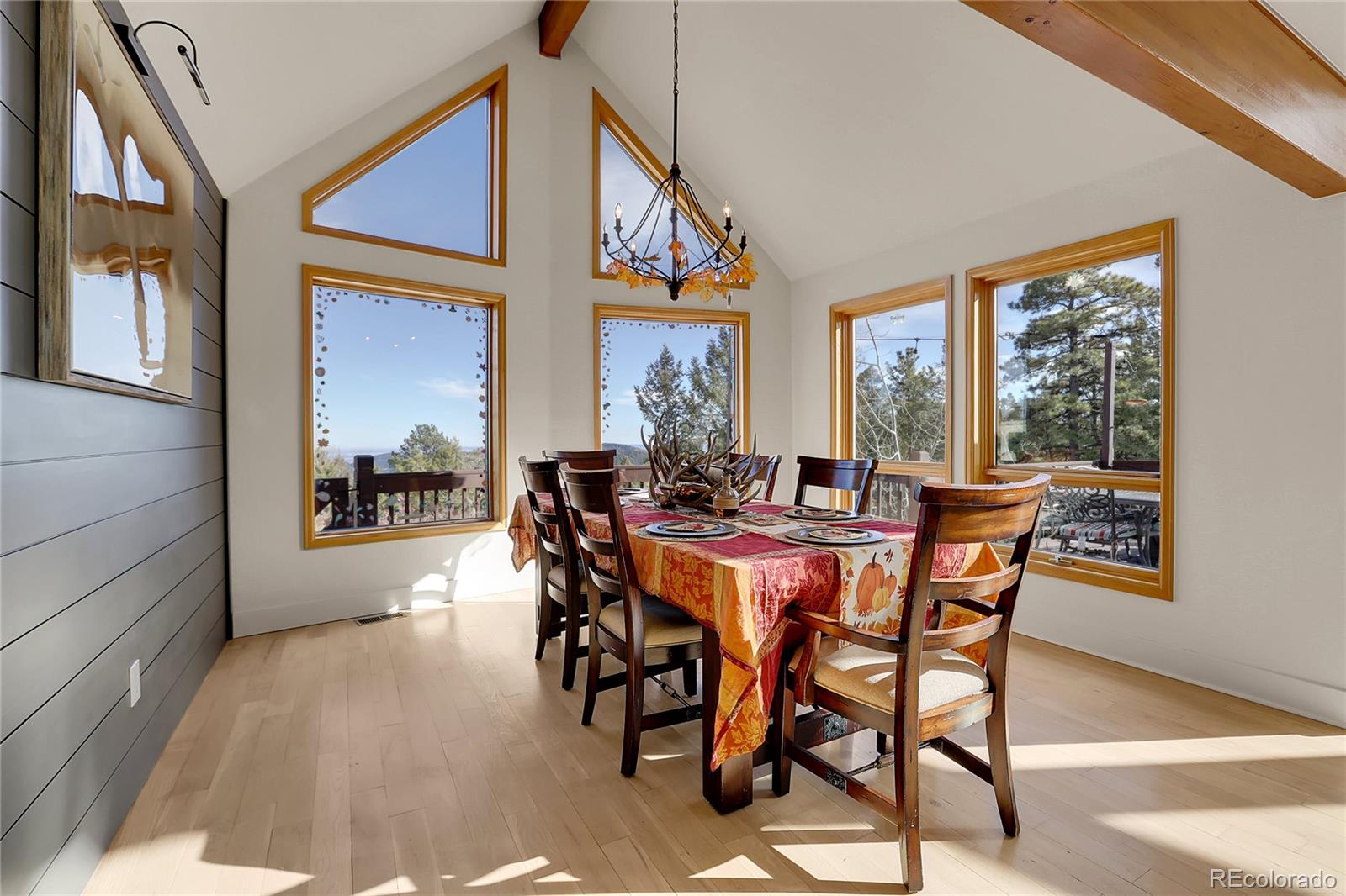 12954 South Ridge Road Conifer, CO 80433 - Photo 7 of 24 a view of a dining room and livingroom with furniture window and wooden floor