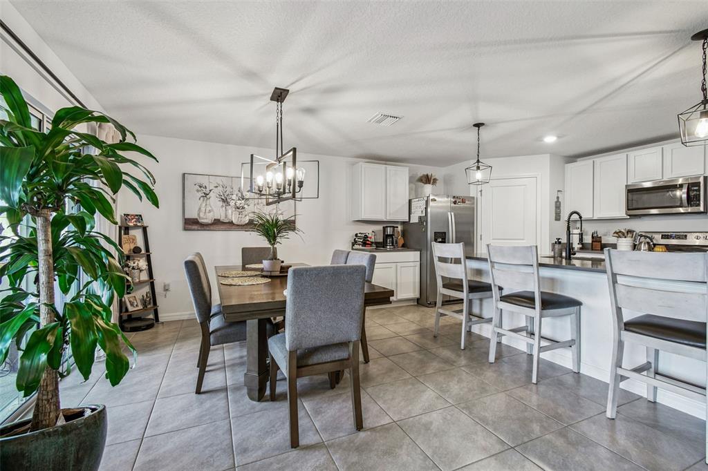 3139 Silver Date Drive Wimauma, FL 33598 - Photo 11 of 47 a view of a dining room with furniture and chandelier