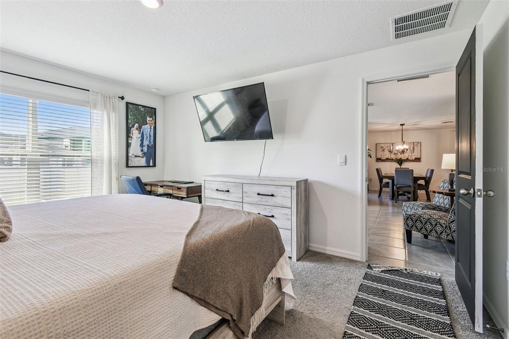 3139 Silver Date Drive Wimauma, FL 33598 - Photo 17 of 47 a bedroom with a bed a mirror and desk