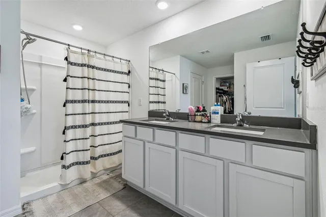 a view of walk in closet with clothes