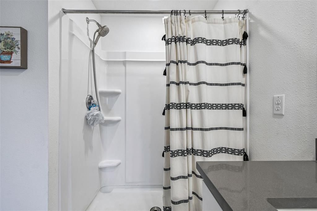 3139 Silver Date Drive Wimauma, FL 33598 - Photo 19 of 47 a bathroom with a granite countertop sink a toilet and shower