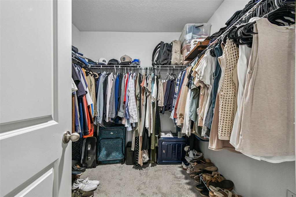 3139 Silver Date Drive Wimauma, FL 33598 - Photo 20 of 47 a view of walk in closet with clothes