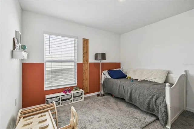 a living room with furniture and a dining table