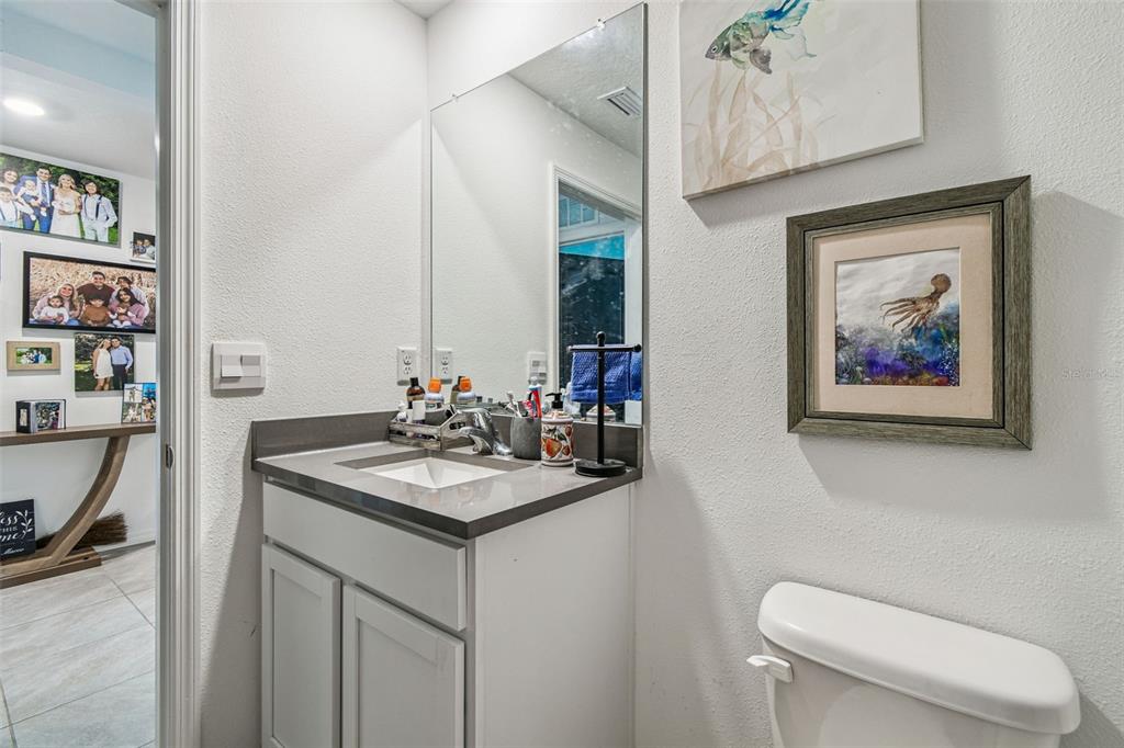 3139 Silver Date Drive Wimauma, FL 33598 - Photo 26 of 47 a bathroom with a toilet a sink and a mirror