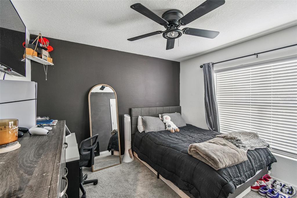 3139 Silver Date Drive Wimauma, FL 33598 - Photo 28 of 47 a bedroom with a bed and a chandelier