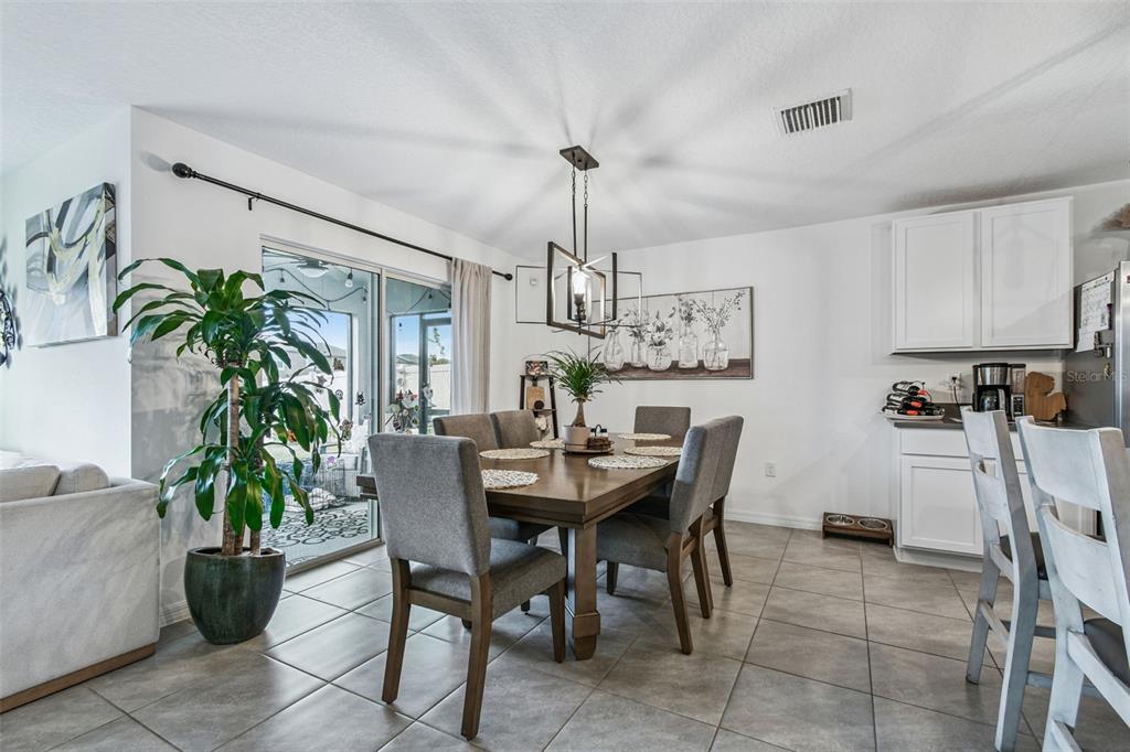 3139 Silver Date Drive Wimauma, FL 33598 - Photo 10 of 47 a dining room with furniture potted plants and wooden floor
