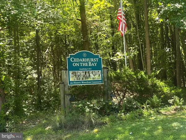 a sign broad in front of the red tree