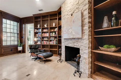 a view of an empty room with cabinet and a fireplace