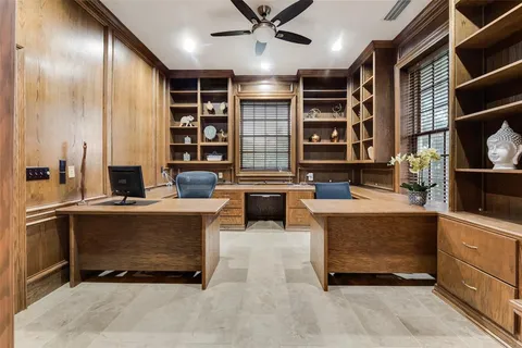 a living room with furniture a fireplace and a large window