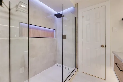 a bedroom with a large bed and a chandelier