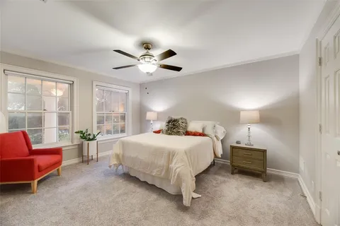 a bedroom with a large bed and a chandelier