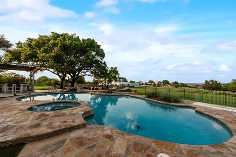 a bedroom with a bed a couch and dresser