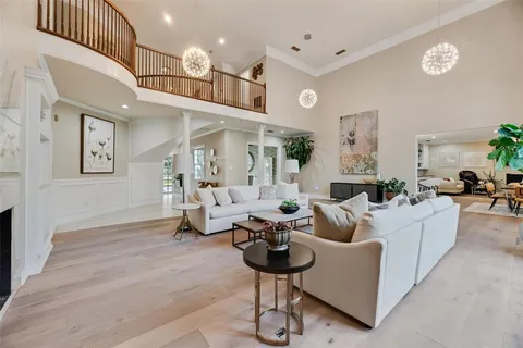 a living room with furniture or chandelier and a wooden floor