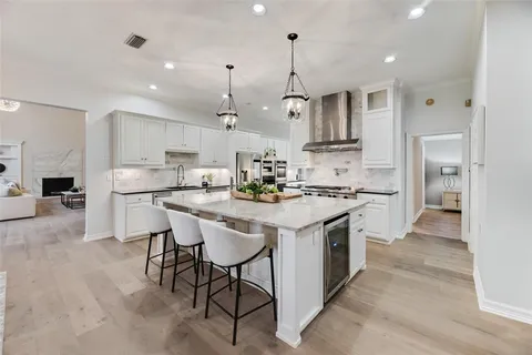 a kitchen with stainless steel appliances kitchen island granite countertop a sink and cabinets