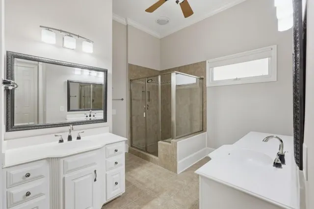 a bathroom with a double vanity sink and mirror