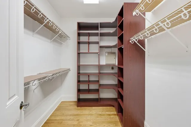 a view of walk in closet with empty racks