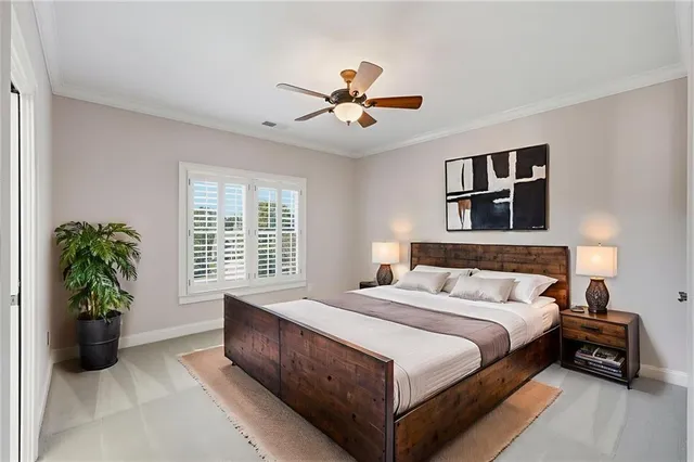 a bedroom with a bed a dresser and a chandelier