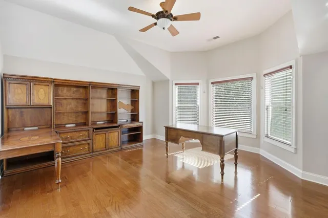 a view of a livingroom with furniture window and wooden floor