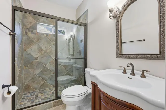 a bathroom with a sink toilet and shower