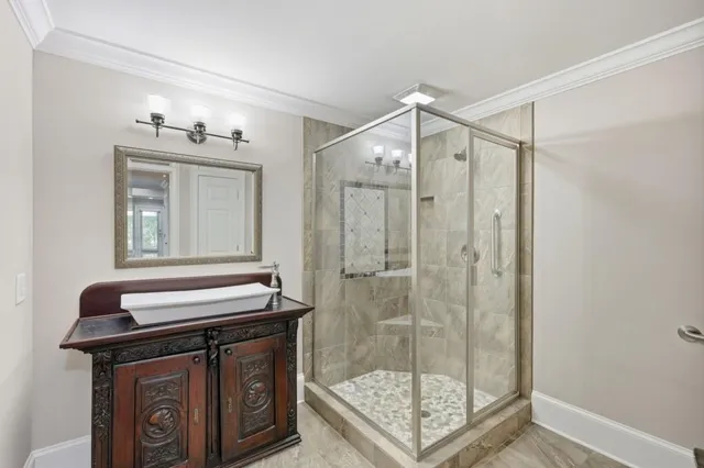 a bathroom with a shower a mirror and a sink