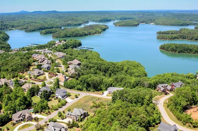 an aerial view of lake residential house with outdoor space and trees