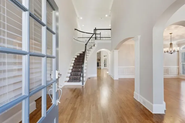 a view of entryway and hall with wooden floor