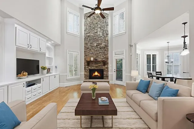 a living room with furniture a flat screen tv and a fireplace