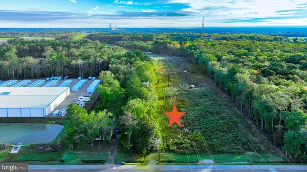 a aerial view of a house with a yard basket ball court and outdoor seating
