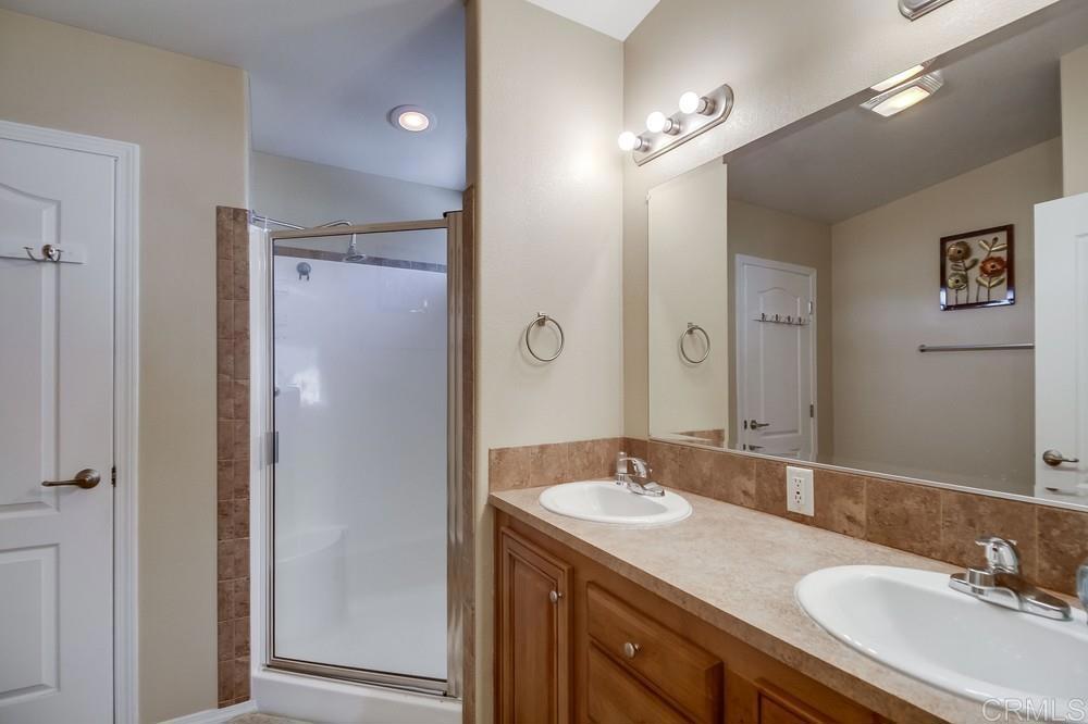 8545 Mission Gorge Road, Unit SPC 232 Santee, CA 92071 - Photo 26 of 30 a bathroom with a granite countertop sink shower and a mirror