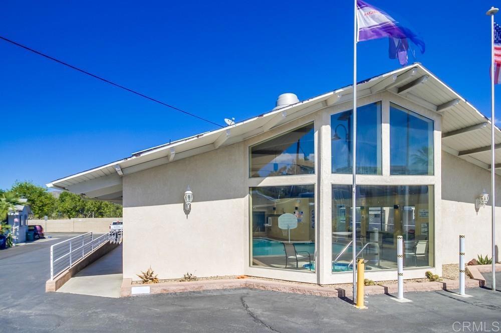 8545 Mission Gorge Road, Unit SPC 232 Santee, CA 92071 - Photo 28 of 30 a view of a house with a floor to ceiling window and potted plants
