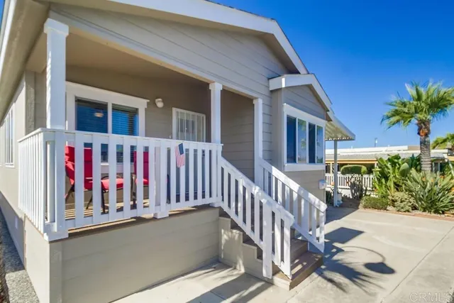 a view of building with glass door and deck