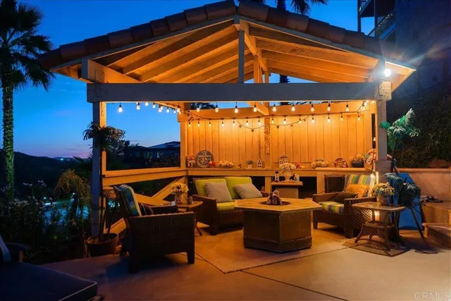 an outdoor living room with patio furniture and a yard