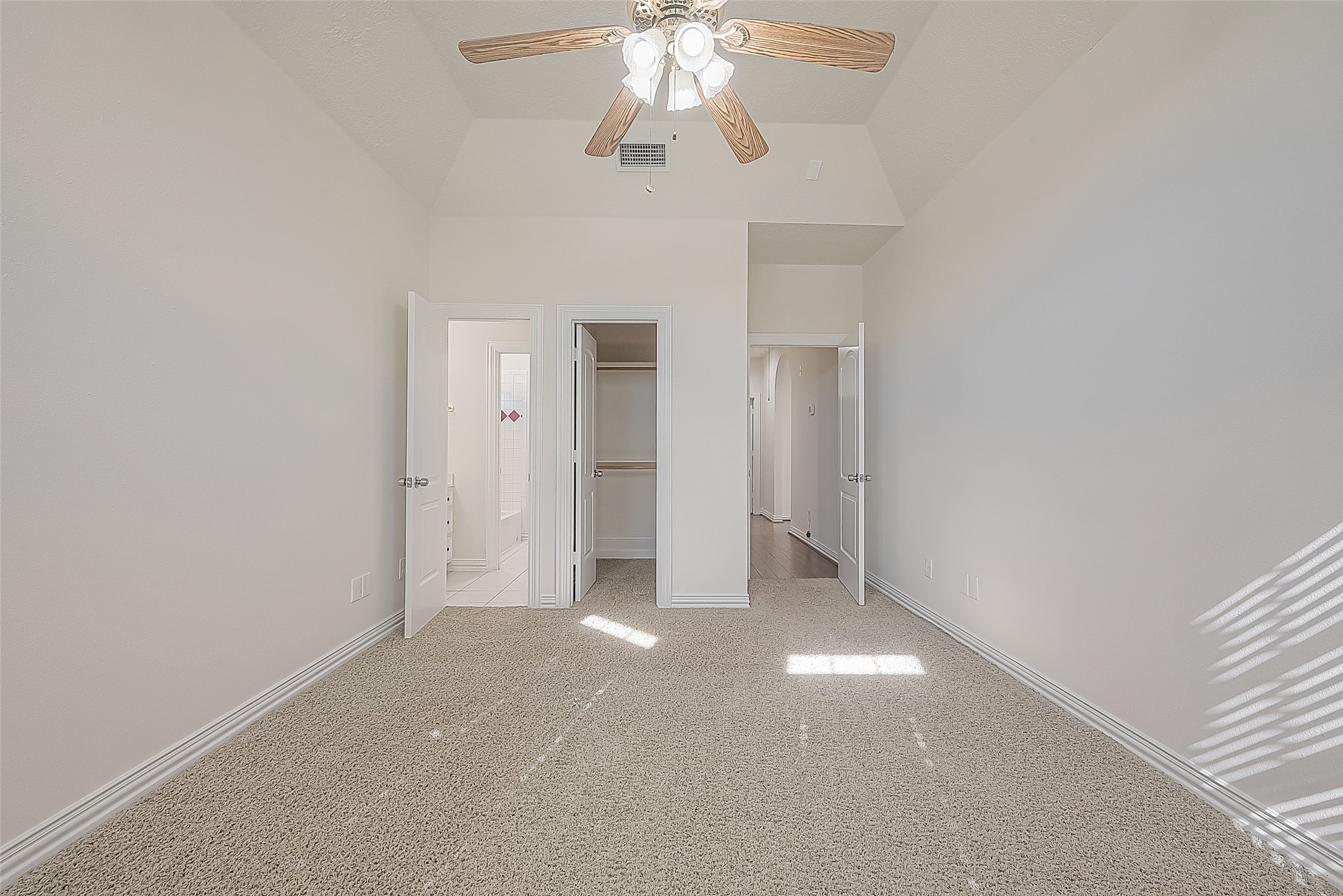 1189 Lovett Street Tomball, TX 77375 - Photo 11 of 36 an empty room with a chandelier fan and closet