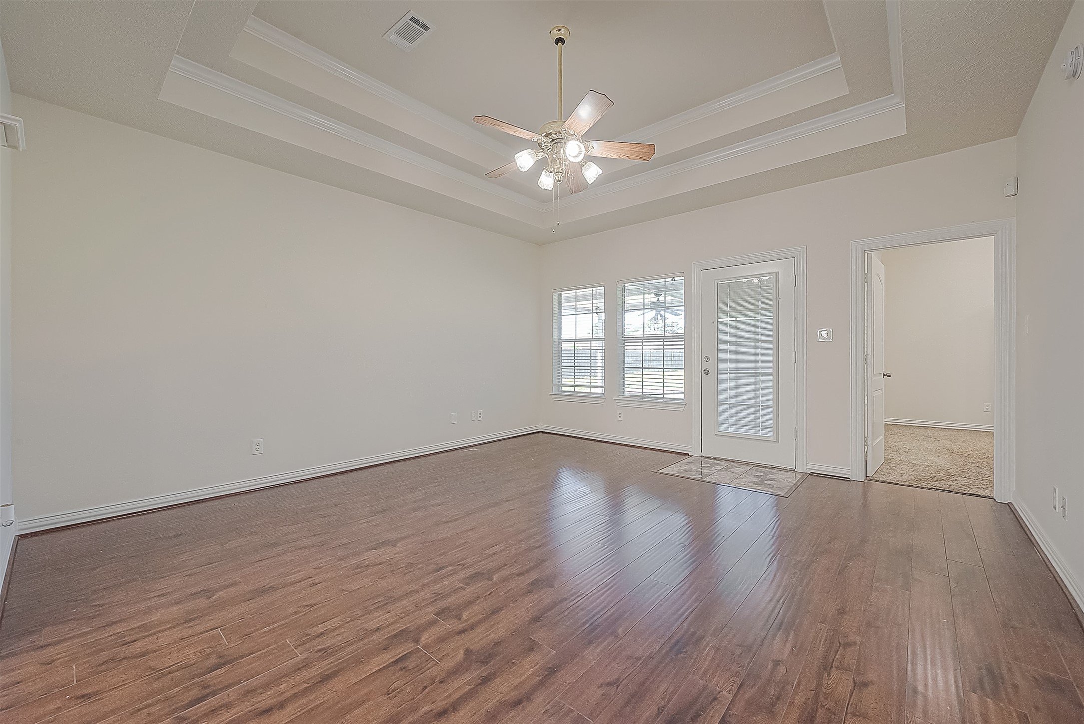 1189 Lovett Street Tomball, TX 77375 - Photo 12 of 36 a view of an empty room with wooden floor and a window