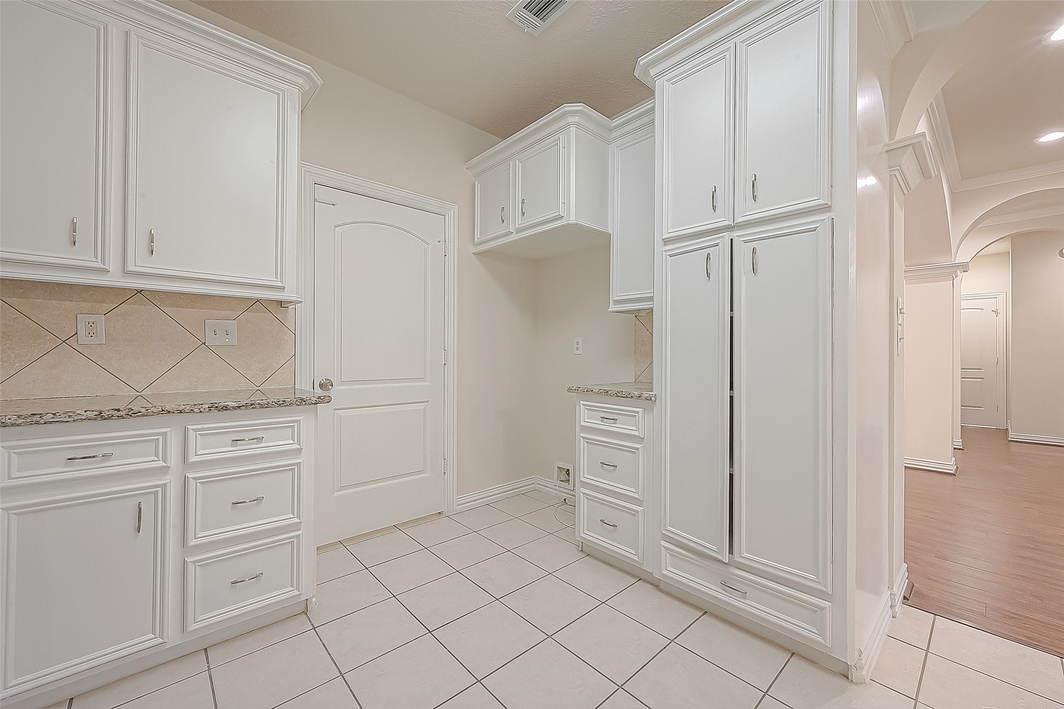 1189 Lovett Street Tomball, TX 77375 - Photo 22 of 36 a kitchen with white cabinets and refrigerator