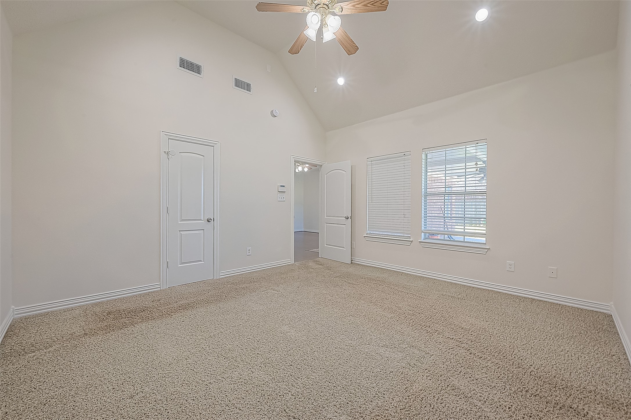 1189 Lovett Street Tomball, TX 77375 - Photo 26 of 36 an empty room with chandelier fan and windows