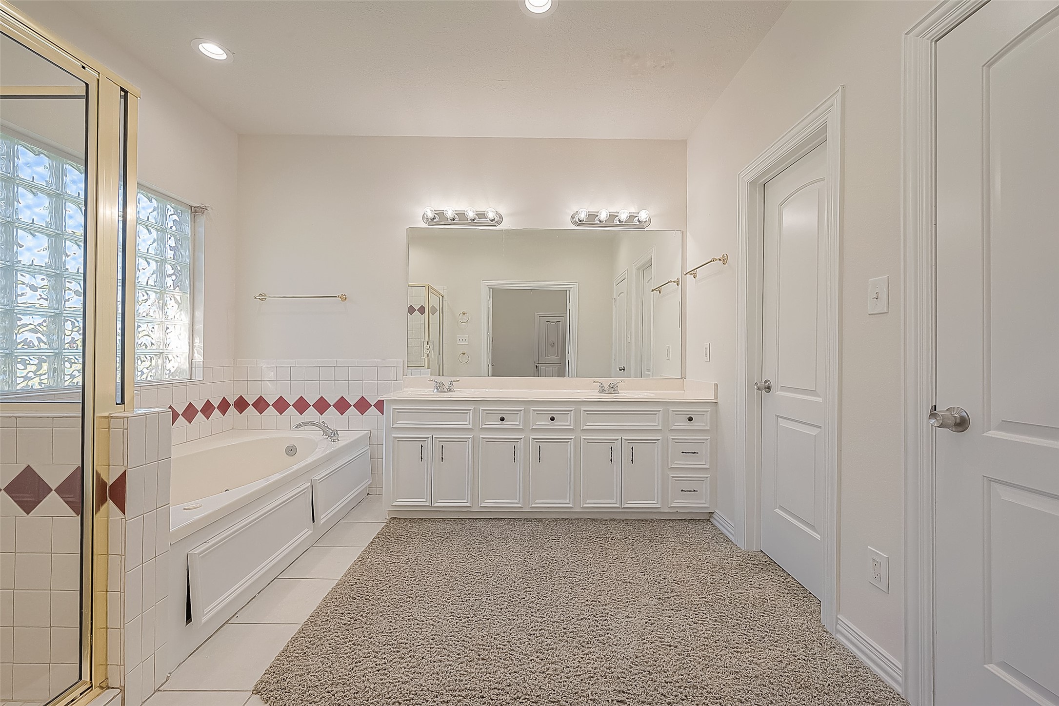 1189 Lovett Street Tomball, TX 77375 - Photo 27 of 36 a bathroom with a tub sink and mirror