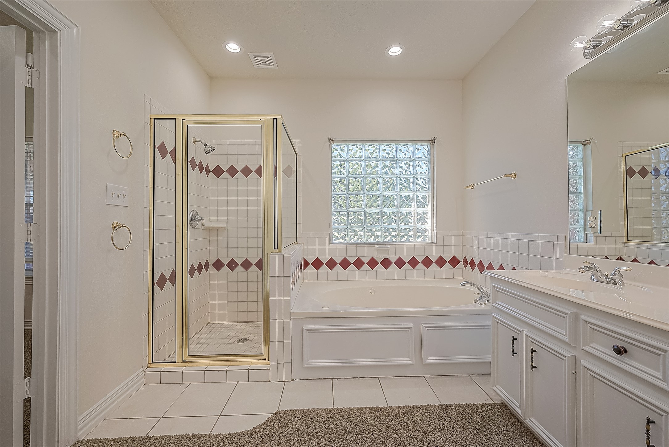 1189 Lovett Street Tomball, TX 77375 - Photo 28 of 36 a bathroom with a double vanity sink mirror and bathtub