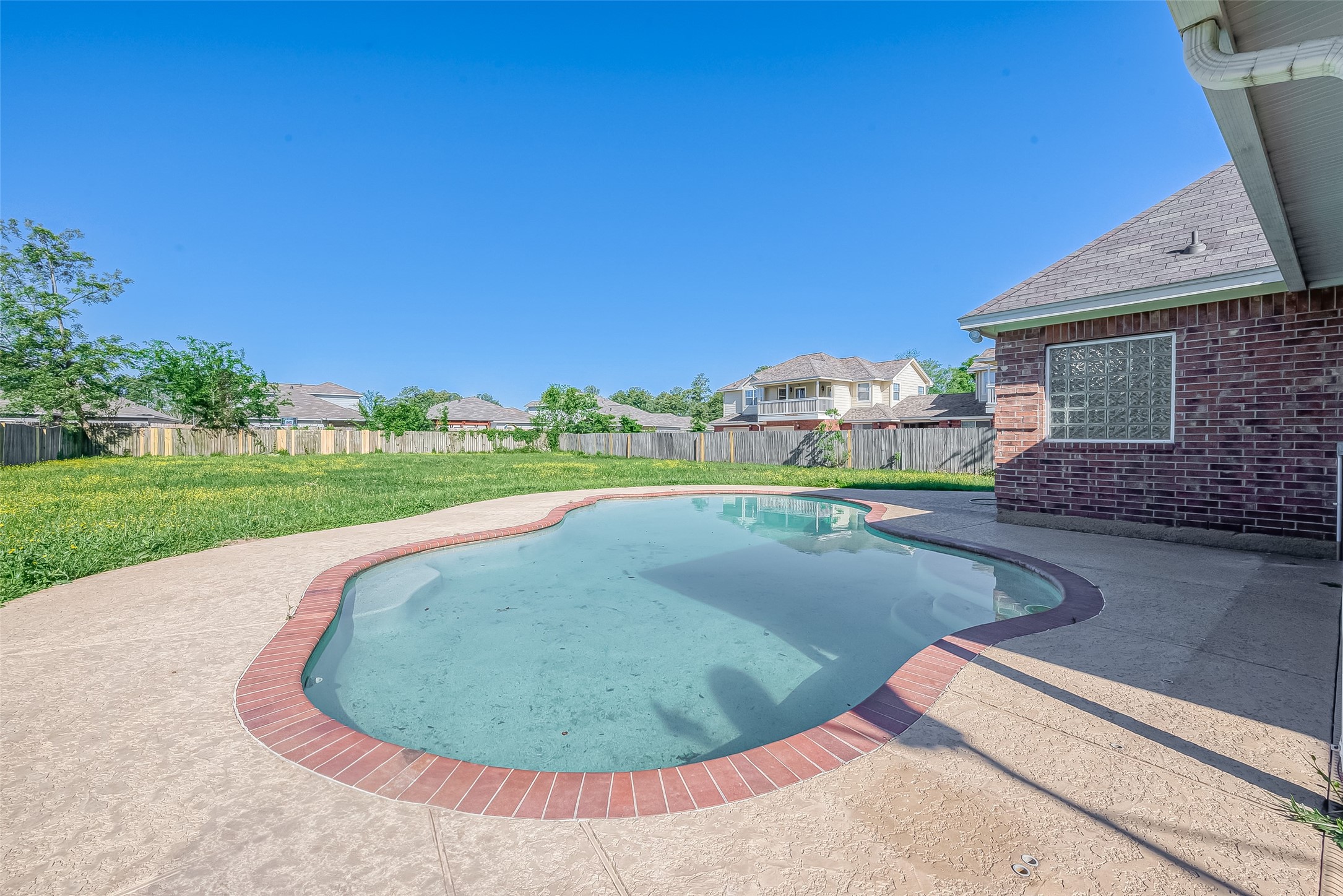 1189 Lovett Street Tomball, TX 77375 - Photo 32 of 36 a view of a swimming pool with a yard