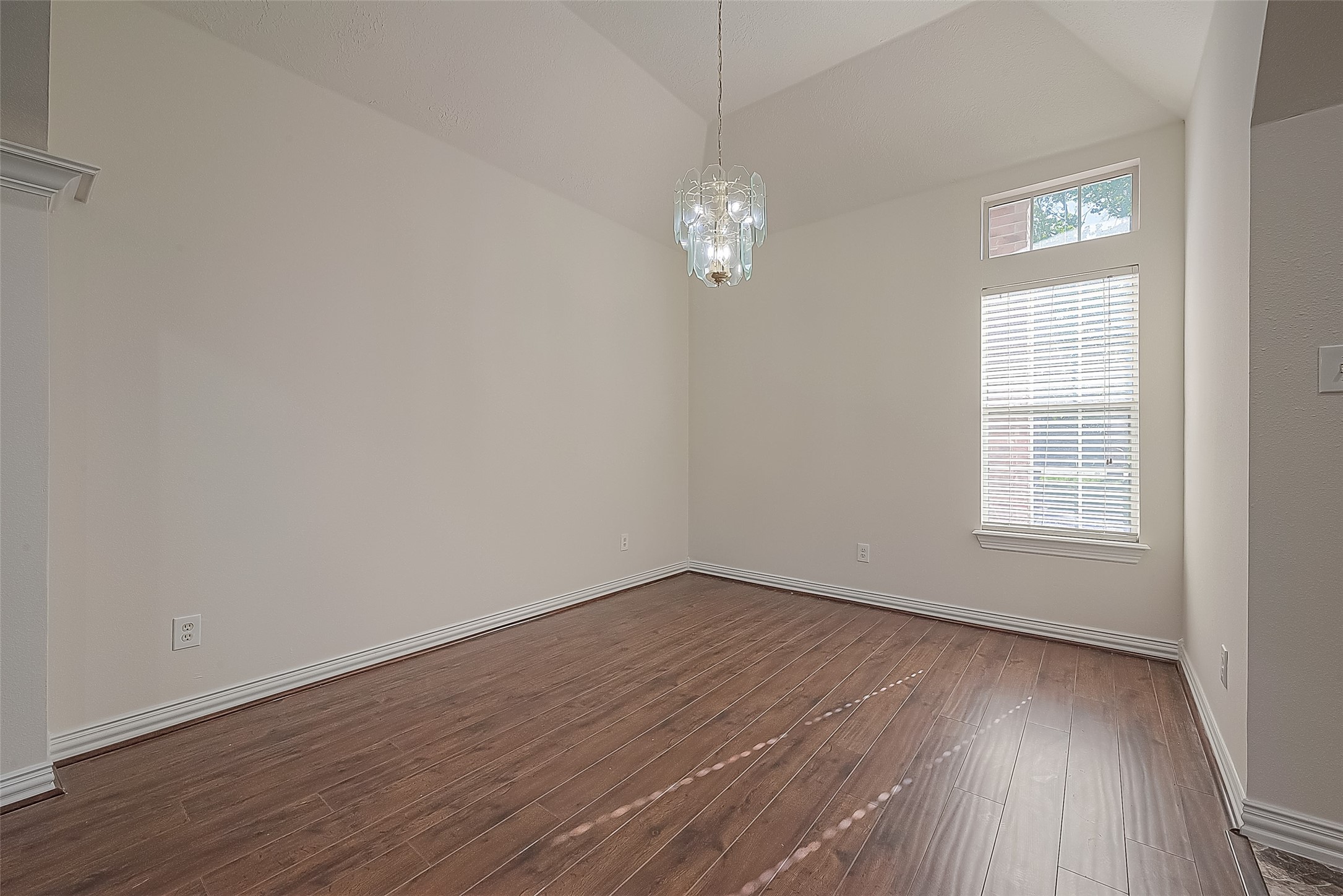1189 Lovett Street Tomball, TX 77375 - Photo 4 of 36 an empty room with wooden floor and windows
