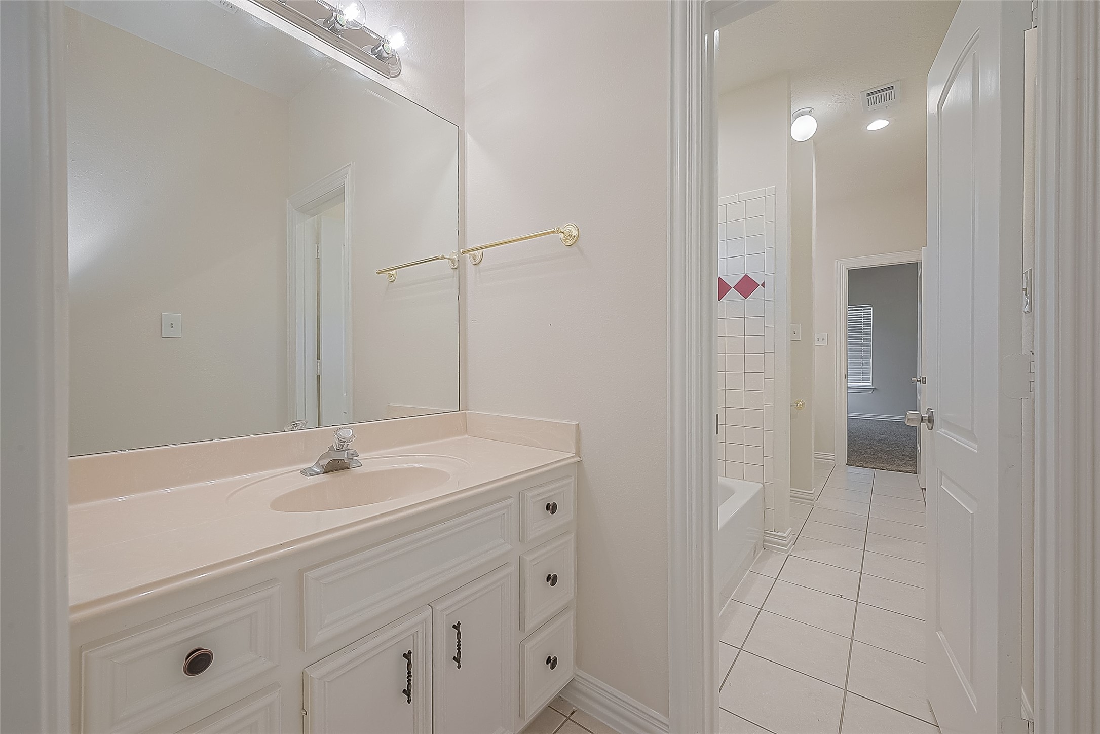 1189 Lovett Street Tomball, TX 77375 - Photo 8 of 36 a bathroom with a sink and a mirror