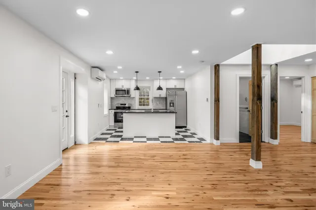 a view of a kitchen with kitchen island microwave and refrigerator